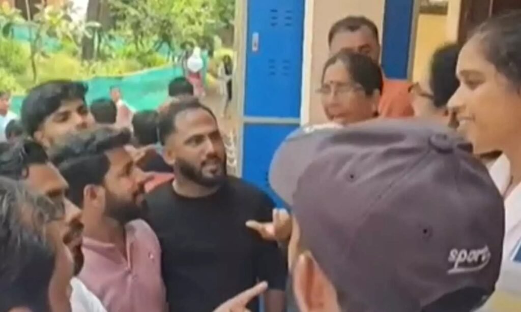 Students holding notebooks with drawings of the Palestinian flag during a school protest in Kasaragod.