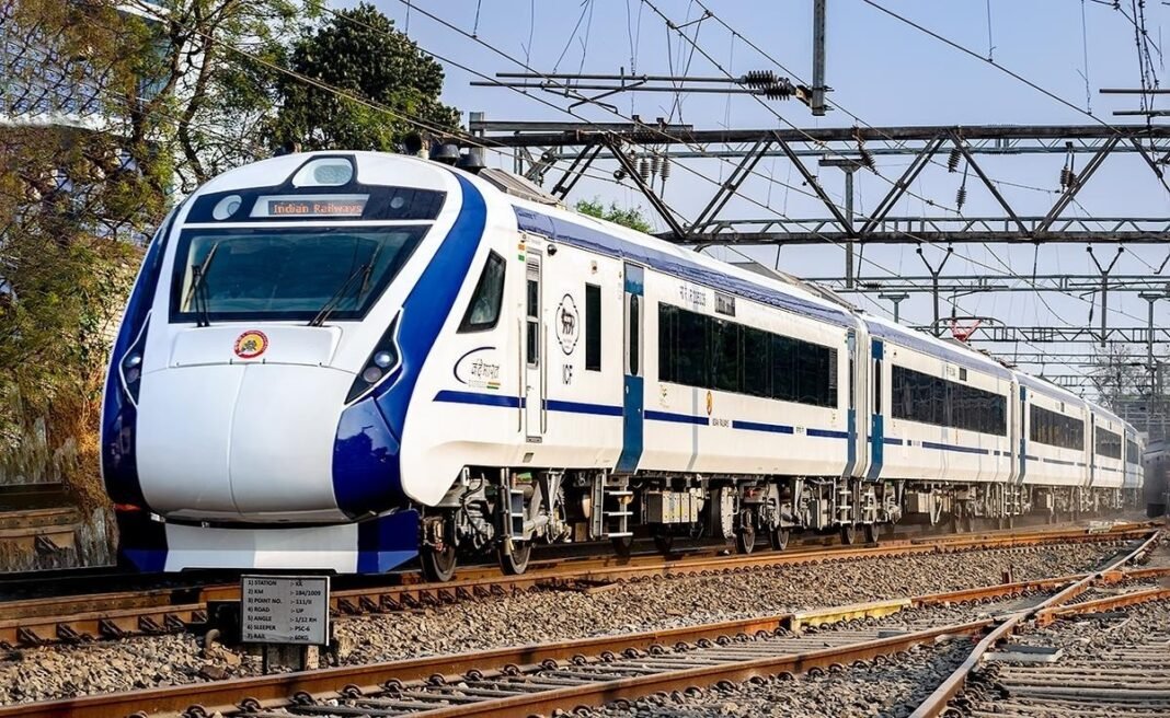 Vande Bharat Express train at Ernakulam station with passengers waiting to board.