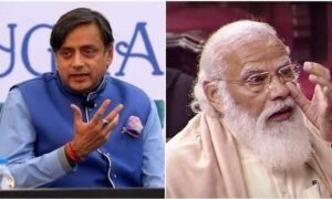Congress MP Shashi Tharoor speaking at an event, with an image of PM Narendra Modi in the background.