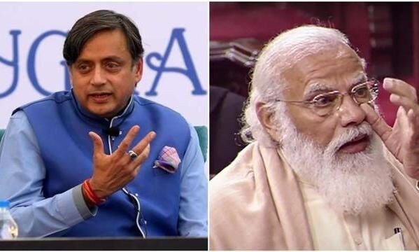 Congress MP Shashi Tharoor speaking at an event, with an image of PM Narendra Modi in the background.