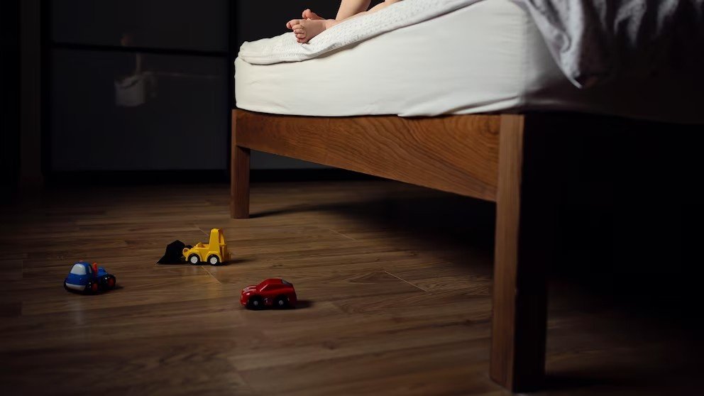 A king cobra being rescued by forest officials from a house in Kannur after being found hiding under a bed.