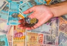 A person making a UPI payment using a smartphone at a retail shop in Kerala.