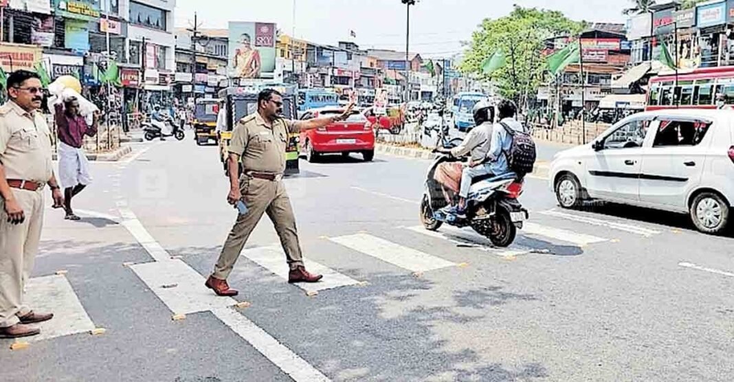 Kerala Police awareness post about zebra crossing rules and pedestrian right-of-way on busy roads.