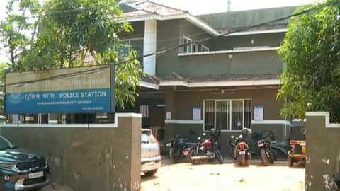 Alt Text: Kerala Police emblem outside a station with a symbolic representation of a mobile phone chat.