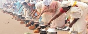 A crowded street in Thiruvananthapuram with women offering Attukal Pongala in earthen pots.