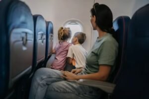 : A family sitting together happily inside an airplane, representing the new PNR seating guidelines.