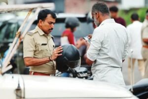 Kerala Traffic Police conducting vehicle inspections and checking helmets during a special road safety drive on a major highway.