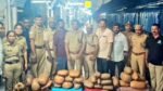 Kerala Excise and RPF officers inspecting seized ganja bags at Chengannur railway station.