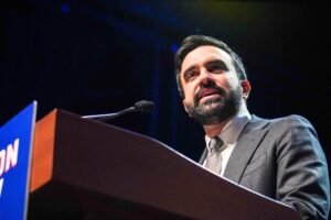 Mayor Zohran Mamdani speaking at a New York City rally about launching municipal grocery stores.