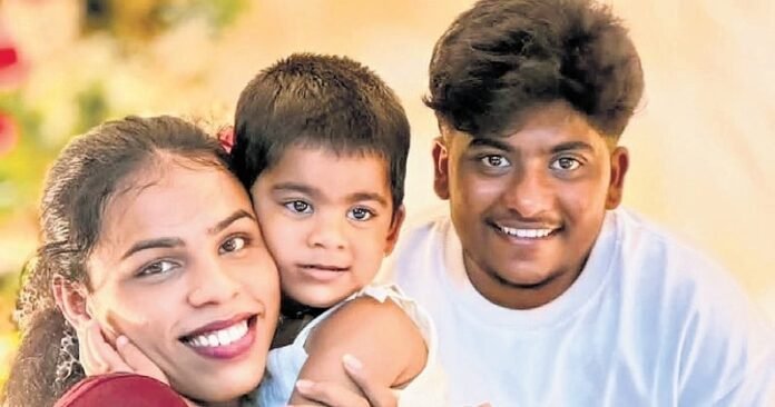 Transgender couple Sahad and Ziya Paval holding their child’s legal document.